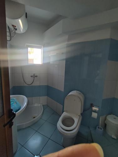 a bathroom with a toilet and a sink at Galia Apartment in Ksamil