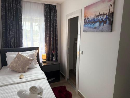 a bedroom with a bed and a window at Alsago Lux in Sesvete
