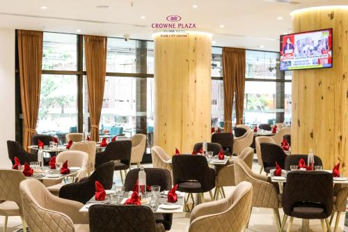 a restaurant with tables and chairs with red bows at Crowne Plaza Pune City Centre by IHG in Pune