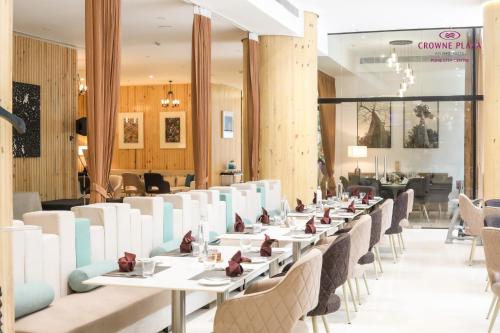 a row of tables and chairs in a restaurant at Crowne Plaza Pune City Centre by IHG in Pune