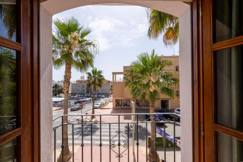 a view from a window of a street with palm trees at BF Rooms Garrucha in Garrucha