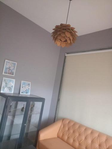 a living room with a couch and a chandelier at Villa A1 in Pali