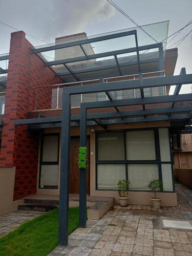 a building with a glass roof with two plants in front at Villa A1 in Pali