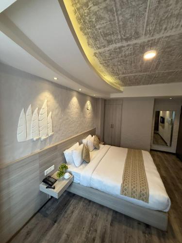 a bedroom with a large white bed with sails on the wall at Vastu Boutique Hotel in Kathmandu