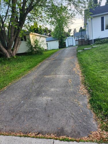 an empty driveway in front of a house at Cozy Sim's in Moncton