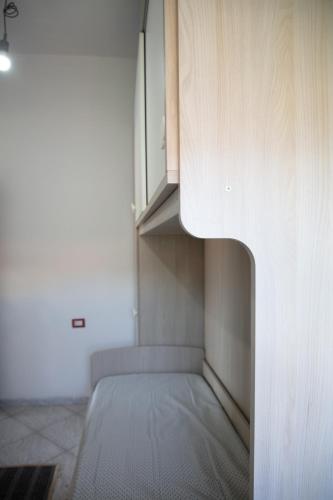 a bedroom with a bed and a cabinet at BIG RIVER HOUSE, Fronte Temo in Bosa Marina
