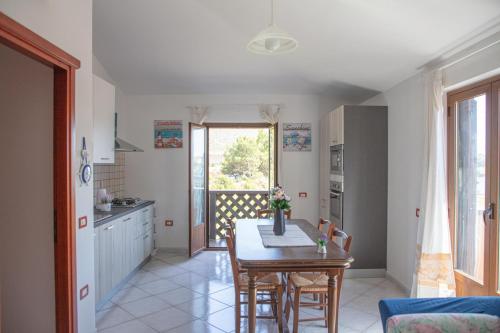 a kitchen and dining room with a table and chairs at BIG RIVER HOUSE, Fronte Temo in Bosa Marina