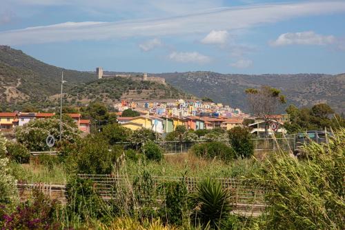 a view of a city from a hill with houses at BIG RIVER HOUSE, Fronte Temo in Bosa Marina