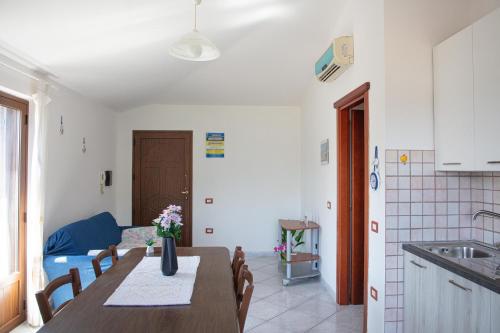 a kitchen and dining room with a table and chairs at BIG RIVER HOUSE, Fronte Temo in Bosa Marina
