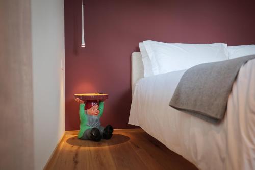 a toy figurine sitting on the floor next to a bed at Villa Amelia in Orta San Giulio