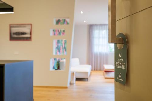 a door with a sign on it in a living room at Villa Amelia in Orta San Giulio