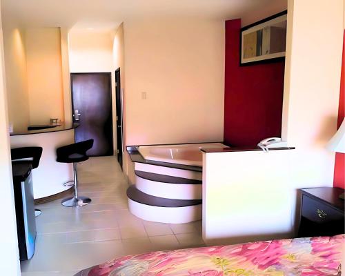 a room with a bed and a bath tub in it at Robinson Inn and Suites in Robinson