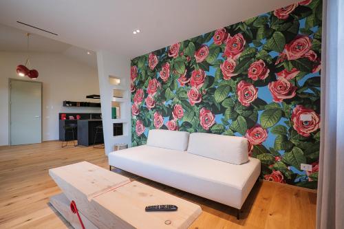 a living room with a mural of roses at Villa Amelia in Orta San Giulio