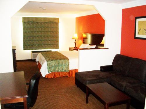 a hotel room with a bed and a couch at Robinson Inn and Suites in Robinson