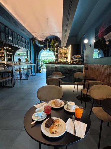 a table with two plates of food on it in a restaurant at Hotel Fiera Wellness & Spa in Bologna