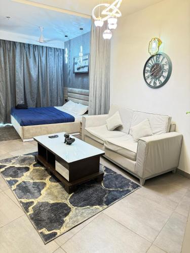 a living room with a couch and a bed at supernova spira in Jāmb