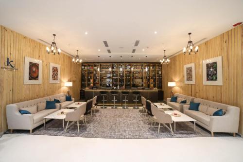 a restaurant with couches and tables and a wine cellar at Crowne Plaza Pune City Centre by IHG in Pune