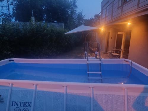 a swimming pool at night with an umbrella at Sweet Secret in Samobor