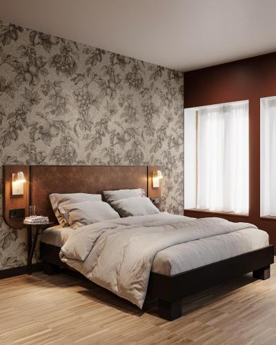 a bedroom with a large bed and a wall at Hota Hotel Porrentruy in Porrentruy