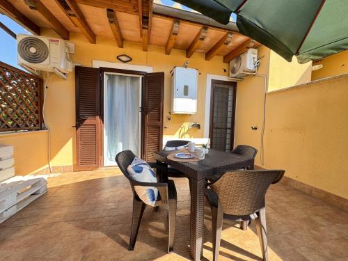 a dining room with a table and chairs in a room at Chalet sul Mare in Ladispoli