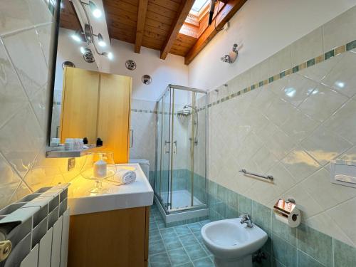 a bathroom with a sink and a shower and a toilet at Chalet sul Mare in Ladispoli