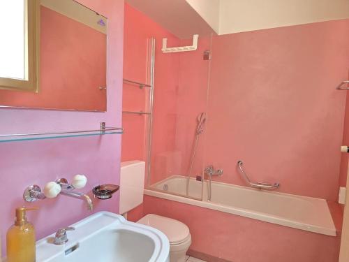 a bathroom with a sink and a toilet and a shower at Palacinema Apartment - Locarno Old Town in Locarno