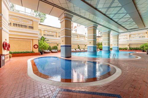 a large building with a pool in the middle of it at Sherwood Residence in Ho Chi Minh City