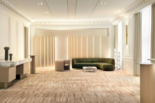 a living room with a green couch and a table at The St. Regis Toronto in Toronto
