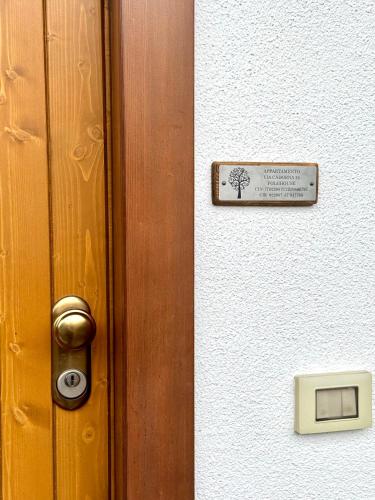 a door with a sign on it with a tree on it at Folghouse in Folgaria