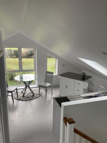 a kitchen and dining room with a table and chairs at Cillarney Lakeview Loft Apartment in Killarney