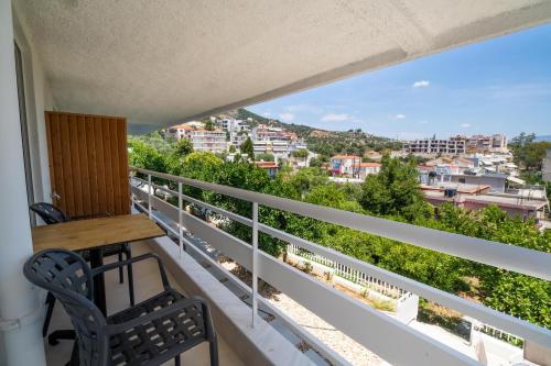 a balcony with a table and chairs and a view at Arancia Elegant Rooms and Suites in Tolo