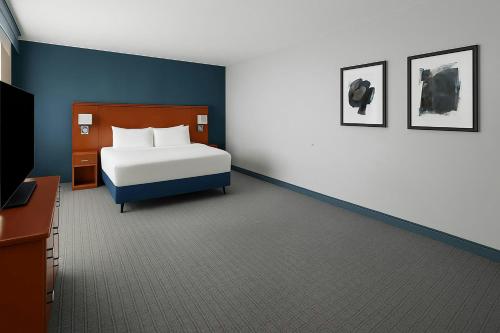 a bedroom with a bed and a tv in it at Courtyard by Marriott Santa Clarita Valencia in Valencia