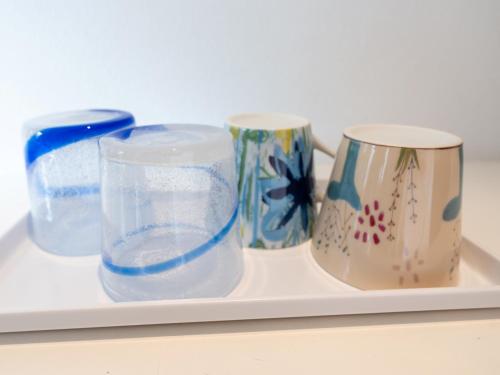 three cups on a tray with water in them at Hotel Art Stay Naha Kokusai-Dori in Naha