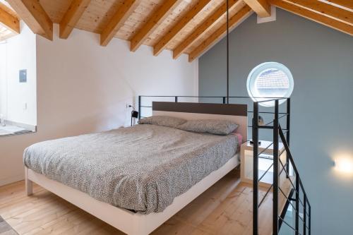 a bedroom with a bed in a room with wooden ceilings at Casa Quadrifoglio - Borromeo in Intra