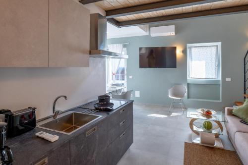 a kitchen with a sink and a counter top at Casa Quadrifoglio - Borromeo in Intra
