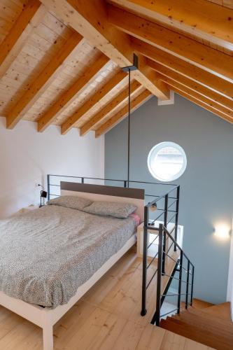 a bedroom with a bed in a room with wooden ceilings at Casa Quadrifoglio - Borromeo in Intra