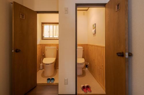 a bathroom with two toilets and a pair of shoes at Nagasaki Kagamiya in Nagasaki