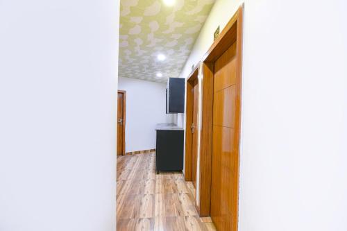 a hallway with a door and a television on a ceiling at FabExpress Jeet Stays - Near Dilshad Garden Metro Station in New Delhi