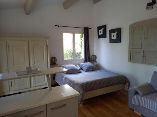 a bedroom with two beds and a sink and a window at GITE AVEC SPA JACUZZI au cœur de Provence Côte d'Azur in Saint Antonin du Var