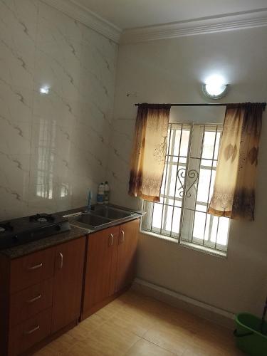 a kitchen with a sink and a window at Peace Home in Lekki