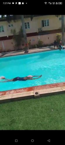 a person swimming in a swimming pool at Peace Home in Lekki
