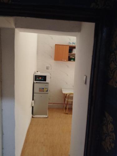 a kitchen with a small refrigerator and a table at Peace Home in Lekki