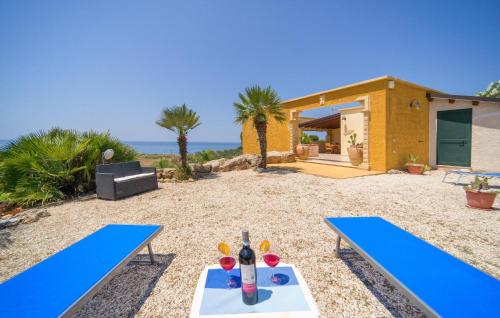 two blue ping pong tables in front of a house at Baglio Mediterraneo in Borgo Bonsignore