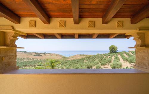 a window in a building with a view of a field at Baglio Mediterraneo in Borgo Bonsignore