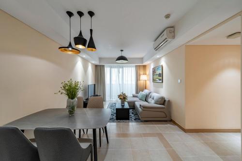 a living room with a table and a couch at Sherwood Residence in Ho Chi Minh City