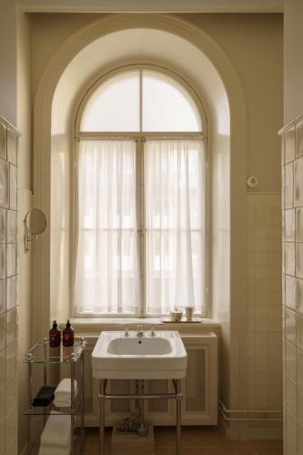 a bathroom with a sink and a window at Stockholm Stadshotell in Stockholm