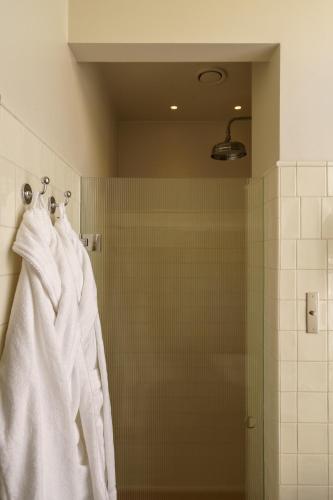 a bathroom with white towels hanging on a shower at Stockholm Stadshotell in Stockholm