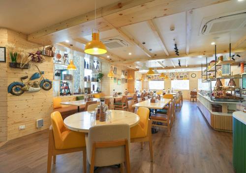 a restaurant with tables and chairs in a room at Bloom Boutique - Rishikesh Hills in Rishīkesh
