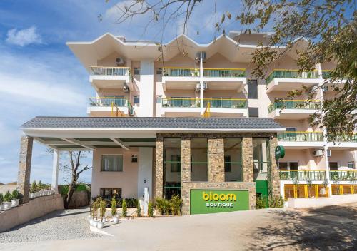 a large white building with a sign in front of it at Bloom Boutique - Rishikesh Hills in Rishīkesh
