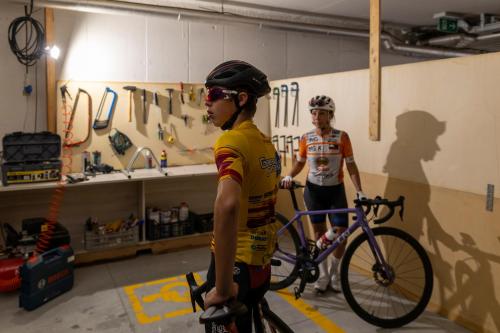 two people in a room with a bike at Grand Hotel Forlì in Forlì